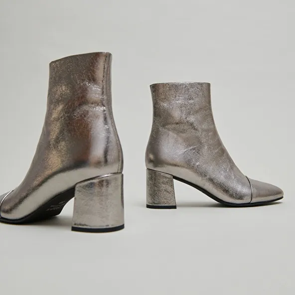 Heeled ankle boots in dark metallic leather