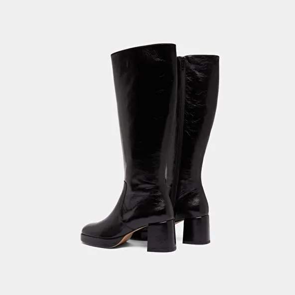 Heeled platform boots in black distressed leather